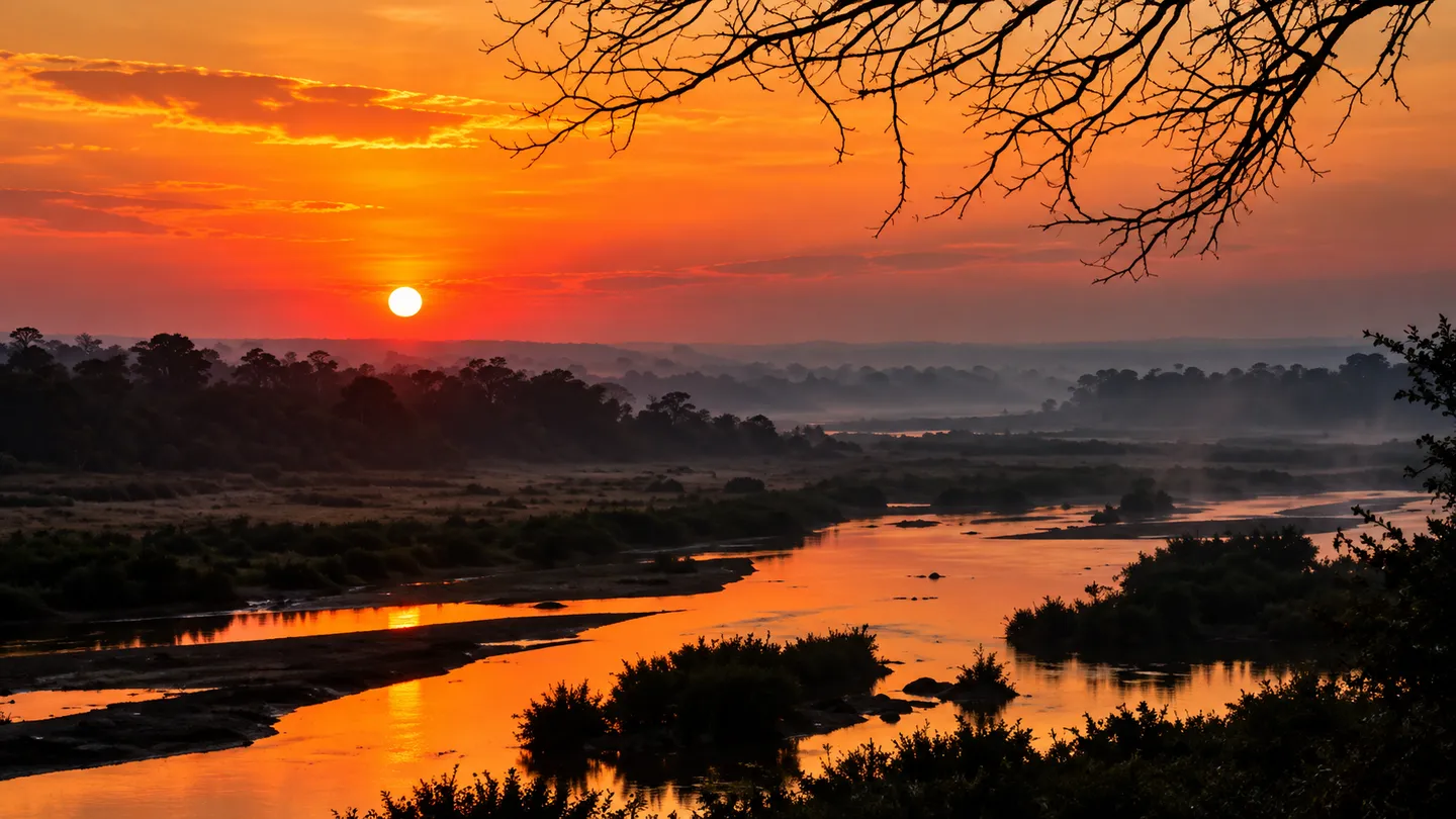 Orange sunset over a river and African bushveld